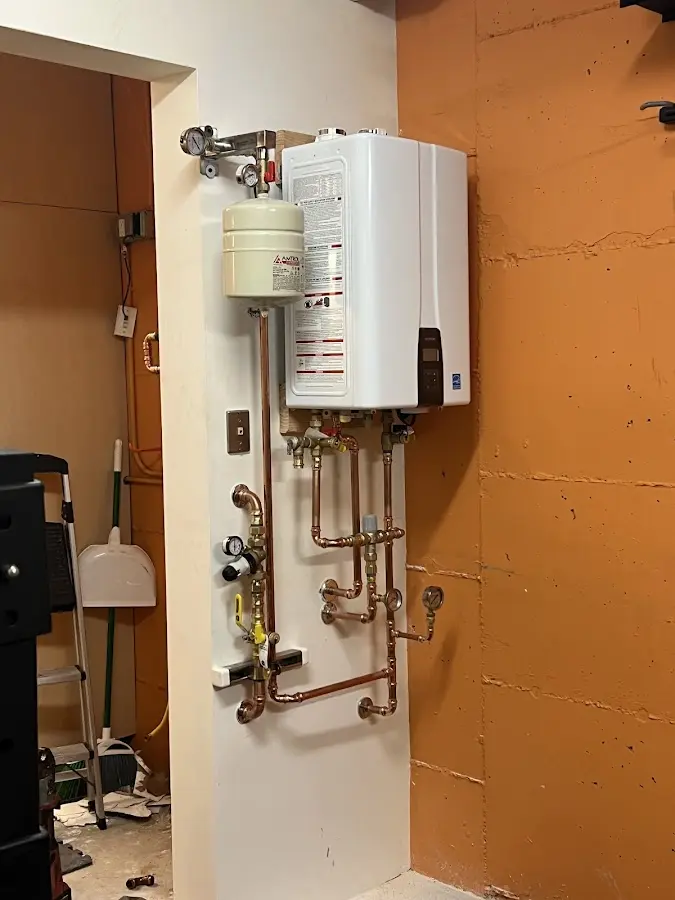 Plumbing technician inspecting water heater connections in Alum Rock